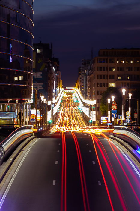 Light trails of traffic on a highway running through a city at night