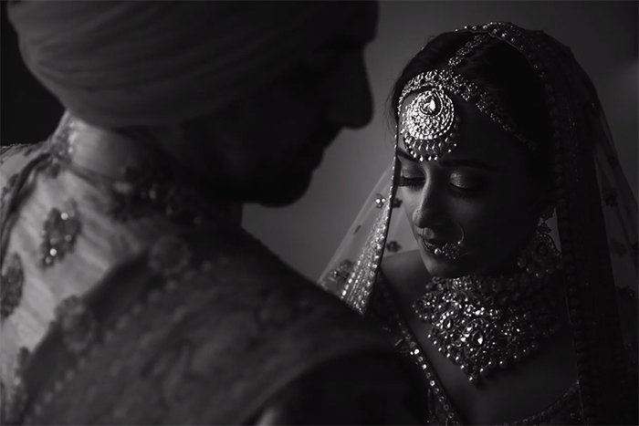 A black and white wedding portrait of an Indian couple