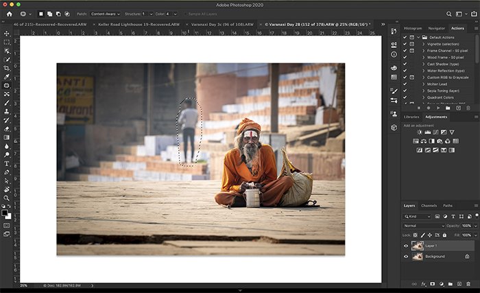 Screenshot of Photoshop workspace showing lasso around person to be removed.