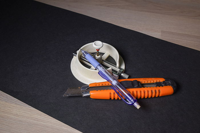 photo of a black cardboard, a pen, and a knife