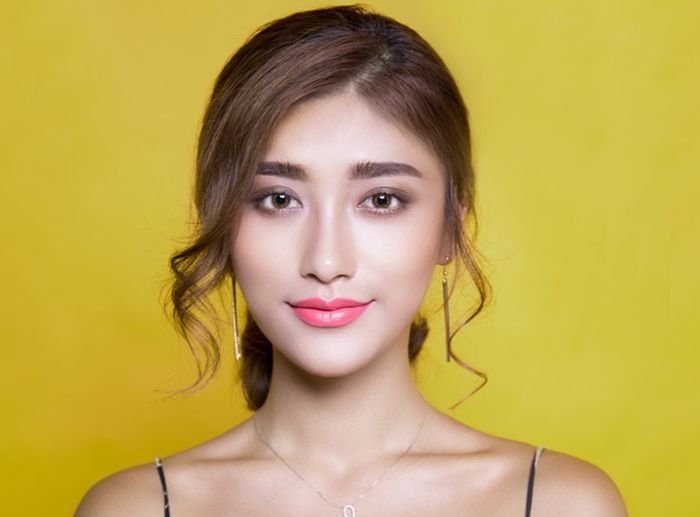 Portrait photo of a girl with yellow background