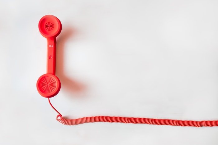 Red telephone on a white background