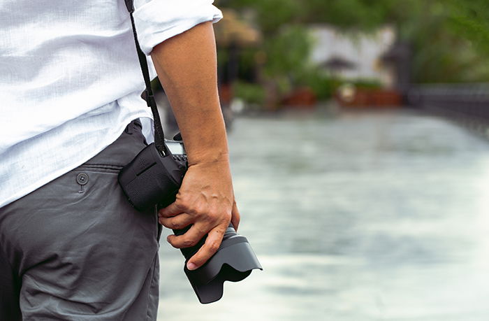 Man with a photo camera in sunlight.