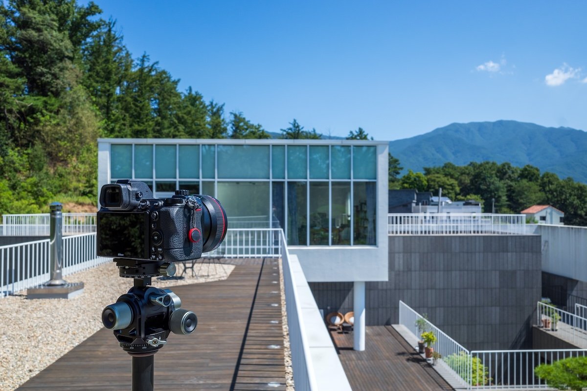A camera on a tripod on a house balcony for real estate photography