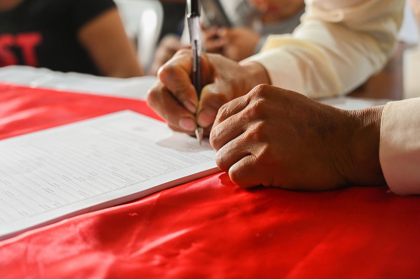 A person signing a photography contract