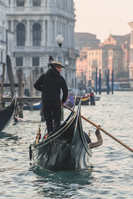 Photo of a man on a gondola in Venice shot using a shallow depth of field