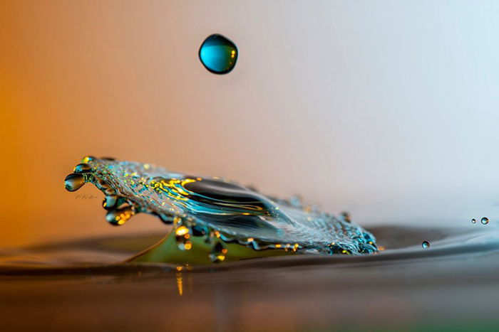 A water droplet dripping on a water surface.