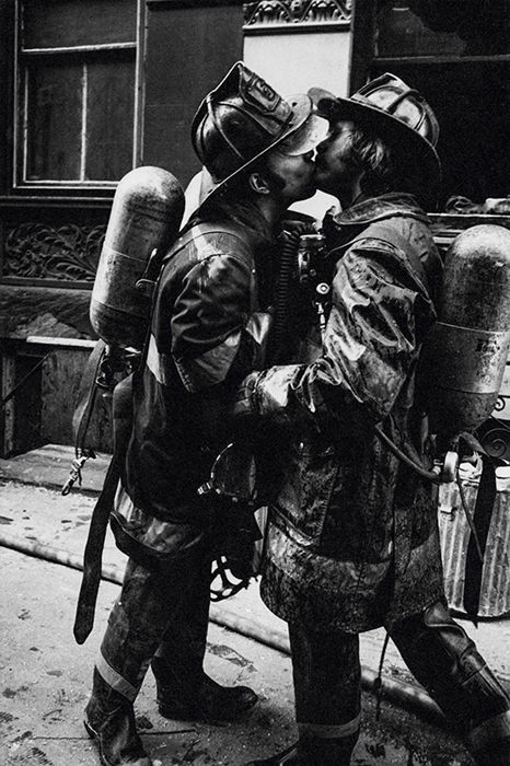 Two firefighters from the FDNY embrace after a 'five-alarm fire', New York City, 1976. Photo by Jill Freedman