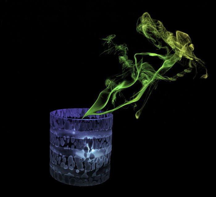 photo of a candle with green smoke