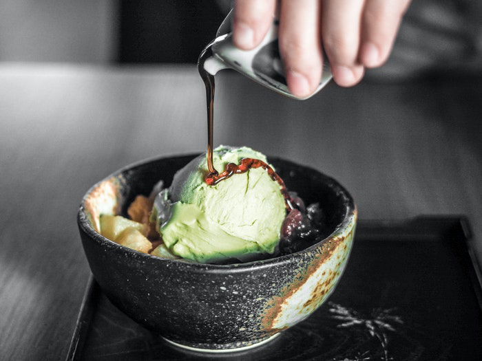 Pouring maple syrup onto ice-cream