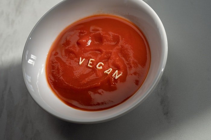 A soup with noodle spelling the word vegan