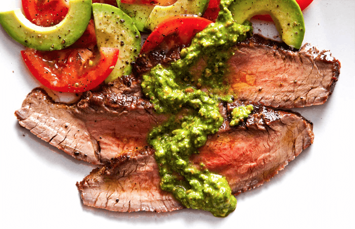 Delicious food photo of slices of meat with tomatoes and avocado 