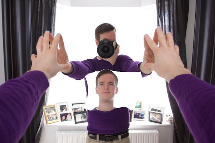 Photo of a man taking a photo of himself in the mirror