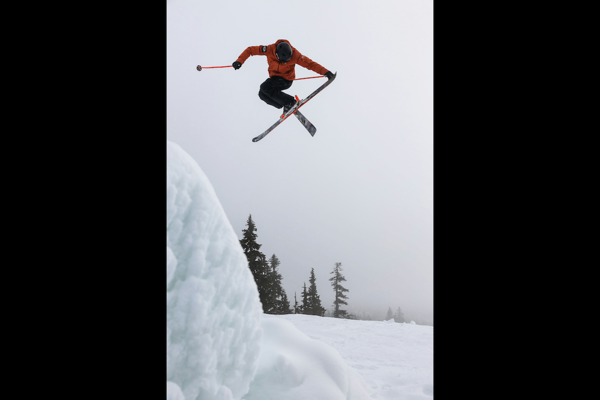A skier twisting in the air doing a trick high above snow for high-speed photography