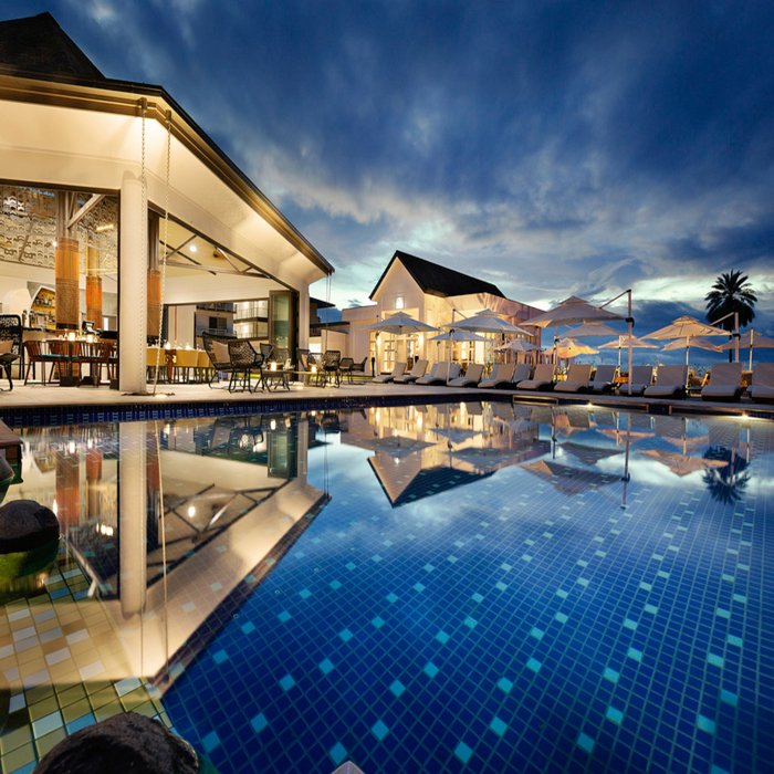 Exterior of a lavish hotel with swimming pool