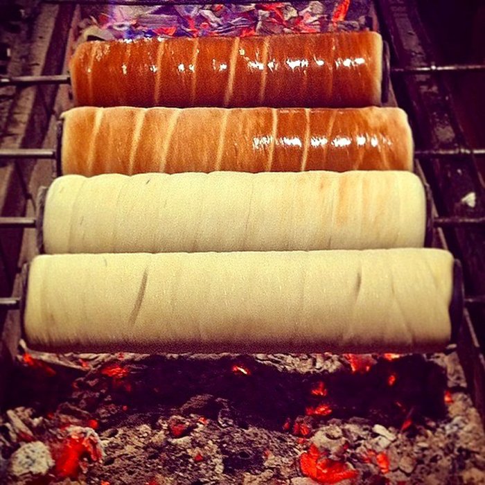 Chimney cakes being cooked on an open fire