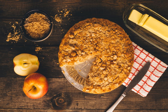 Overhead shot of apple pie on a wooden table