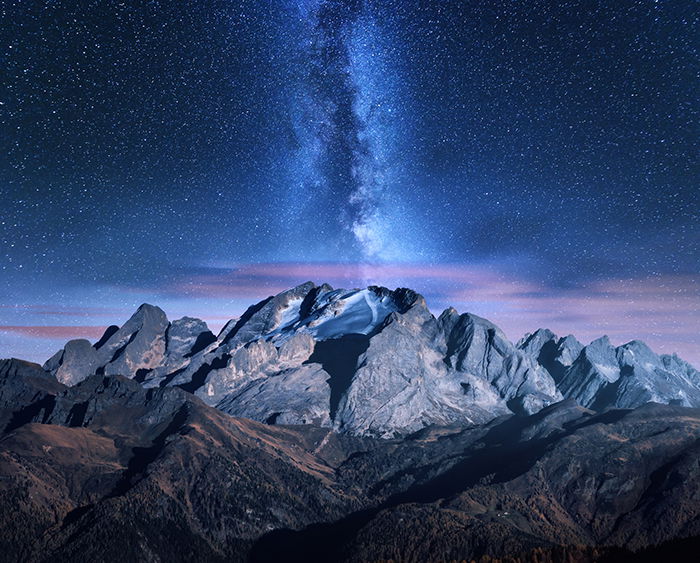 Milky Way and mountains at starry night in autumn.