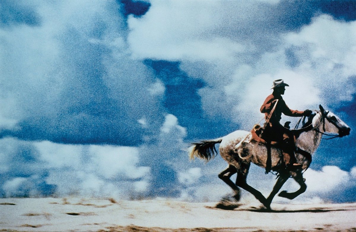 Untitled (Cowboy) by Richard Prince of a man riding a horse with a white cloud and blue sky background as one of the most expensive photographs