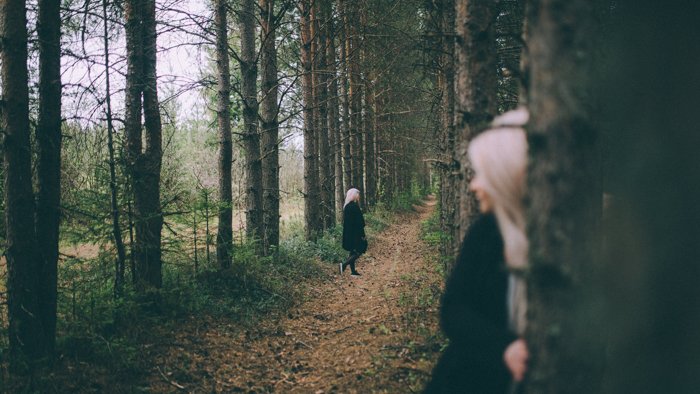 A cloned woman walking in a forest