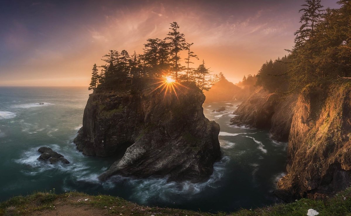 A coastline at sunset with an island and trees by one of the best nature photographers Daniel Kordan