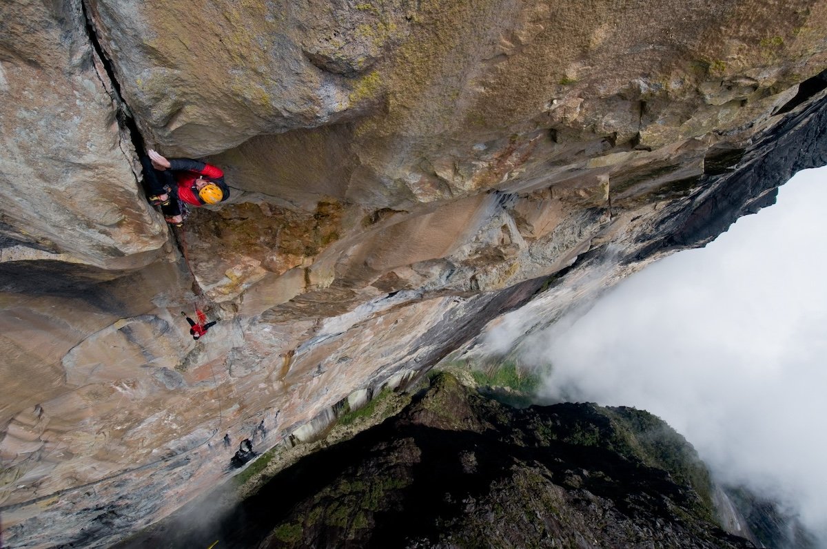 A rock climber with a waterfall by one of the best nature photographers Jimmy Chin