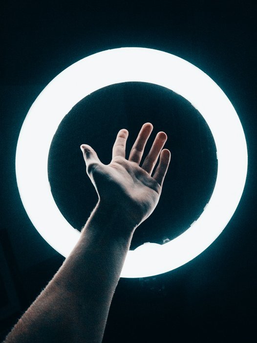 A hand on a ring light