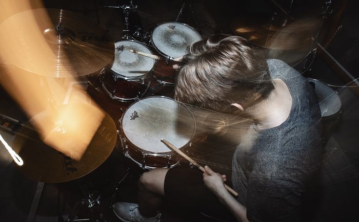 A photo of a drummer shot from a above with some blur and a slow-sync flash