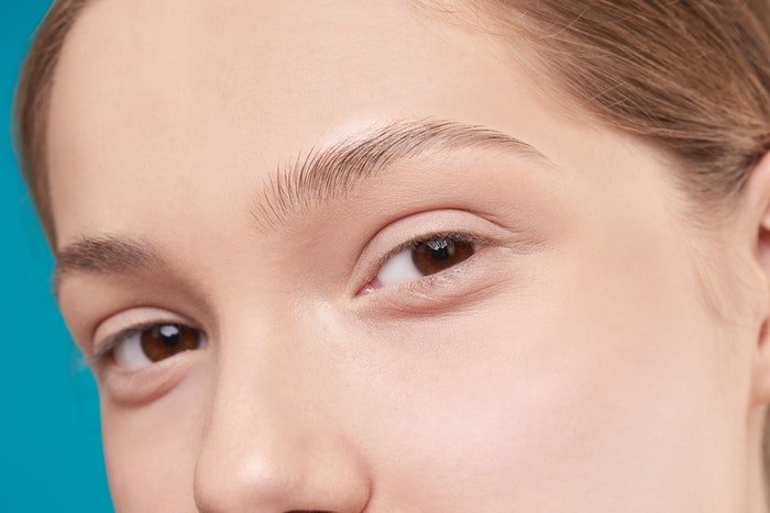Detail of face with skin smoothed in Photoshop