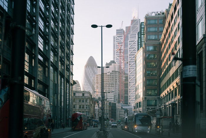 A street view of an urban jungle with skyscrapers in the distance