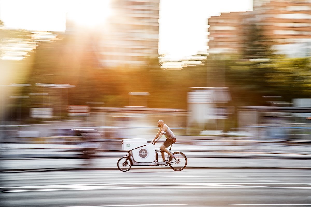 Pan shot of a bicycle courier moving with blurred lines