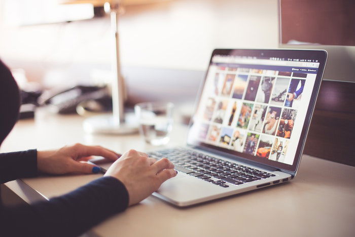 A girl tying on a laptop