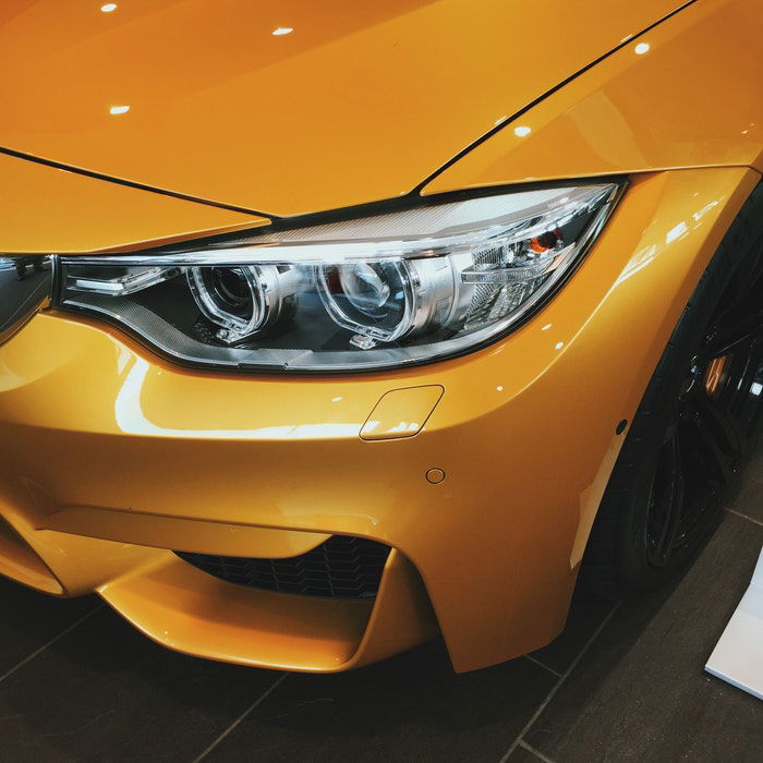 Close-up photo of the front of a gold car