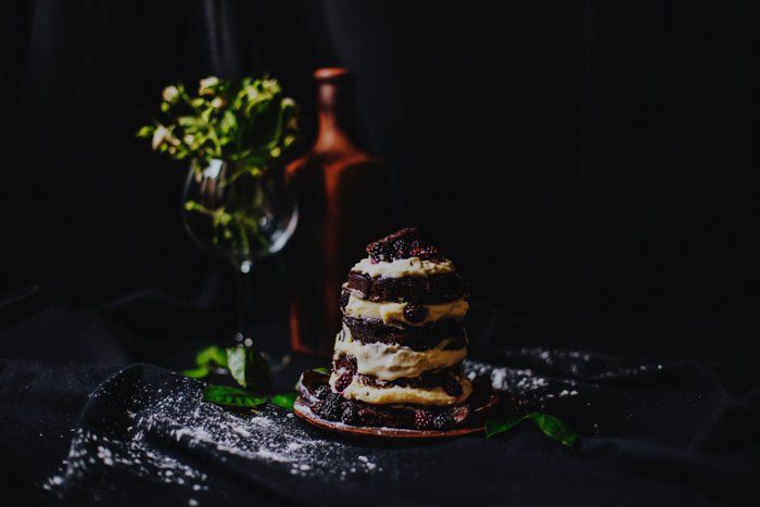 Photo of pancakes with fruits with a dark setting