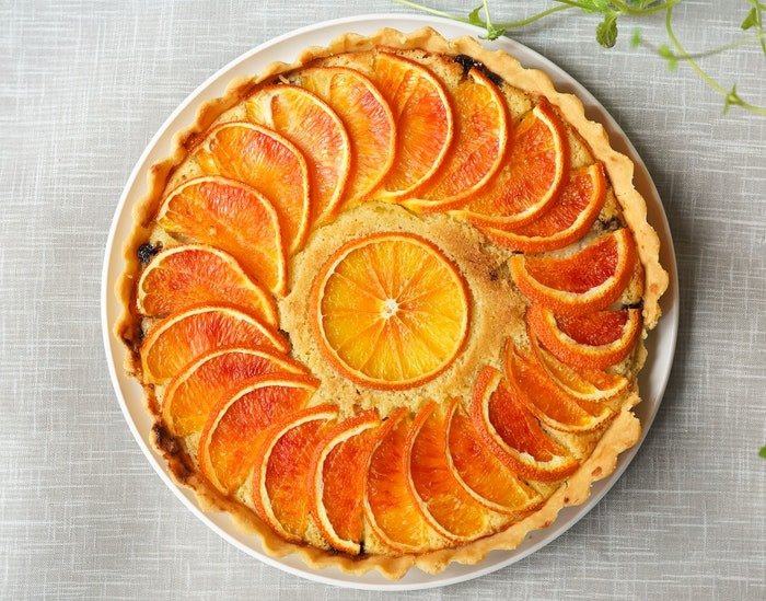 A flat lay photo of a delicious citrus tart