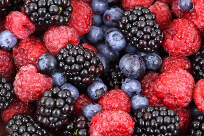 Close up fruit photography of raspberries, blueberries and blackberries