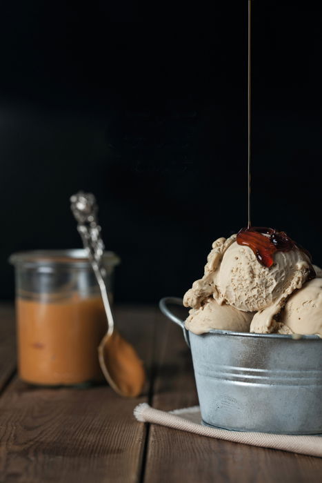 Caramel being poured on an icecream