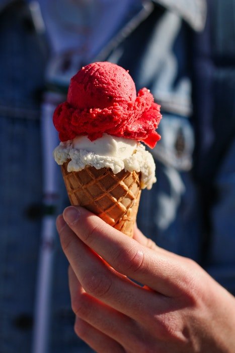 A raspberry and vanilla ice cream cone 