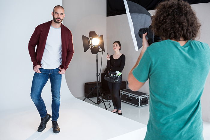 Model posing for a photoshoot in a photo studio with white background.