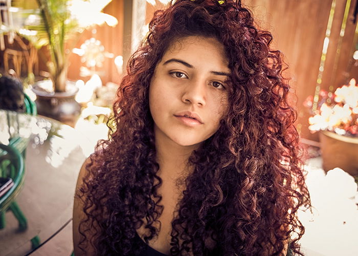 Self-portrait of a woman with curly hair