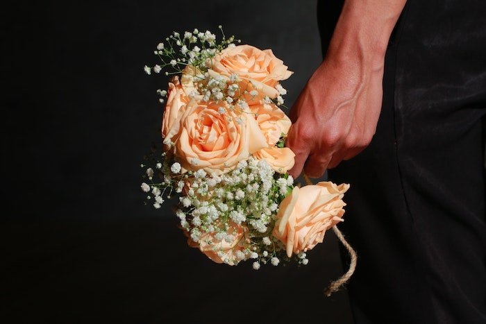 Hand holding a bouquet of flowers