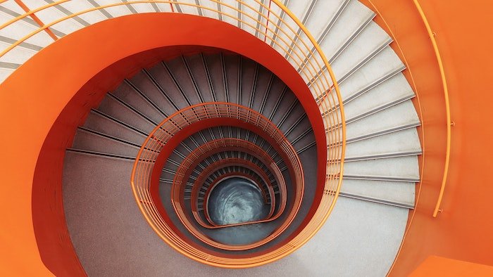 Orange spiral staircase shot from above