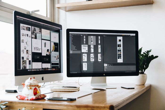 Two computer screens on a desk