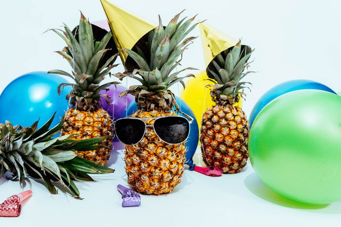 Funky photo of pineapples in sunglasses