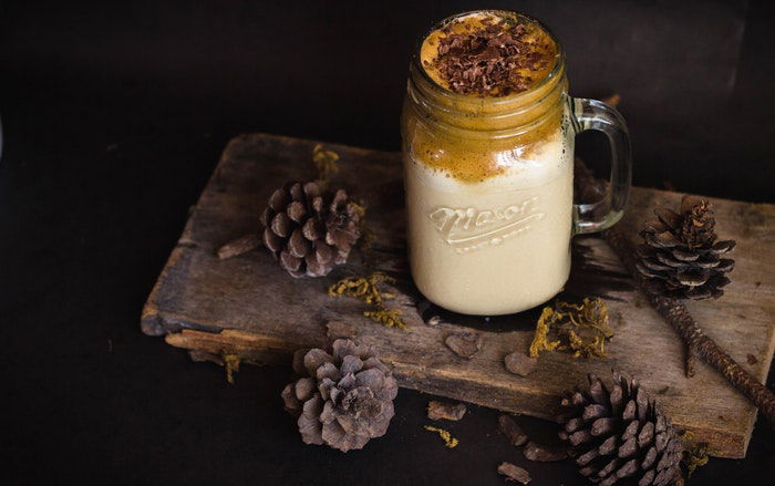 Rustic food photo setup on a wooden board with pine cones