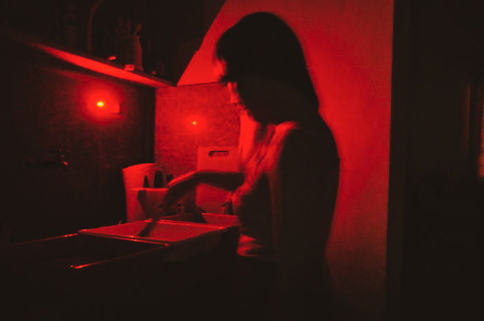 A person in a photography darkroom