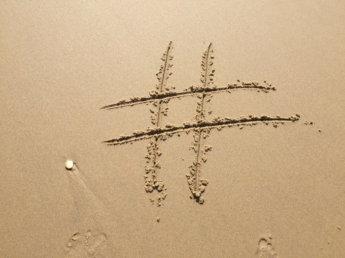 A hashtag drawn in the sand