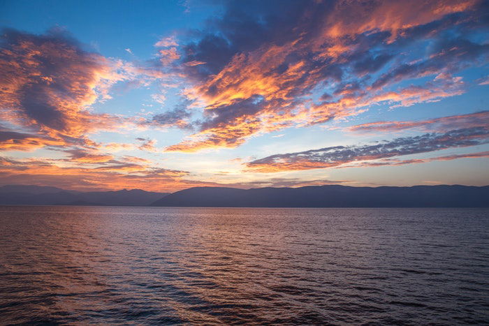 photo of clouds and sunset above a huge waterscape