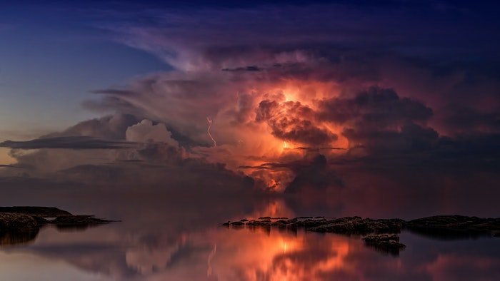 photo of colorful clouds above a waterscape