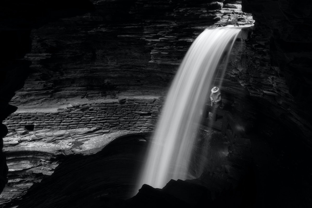 A long exposure of a waterfall in a cave to show exposure in photography